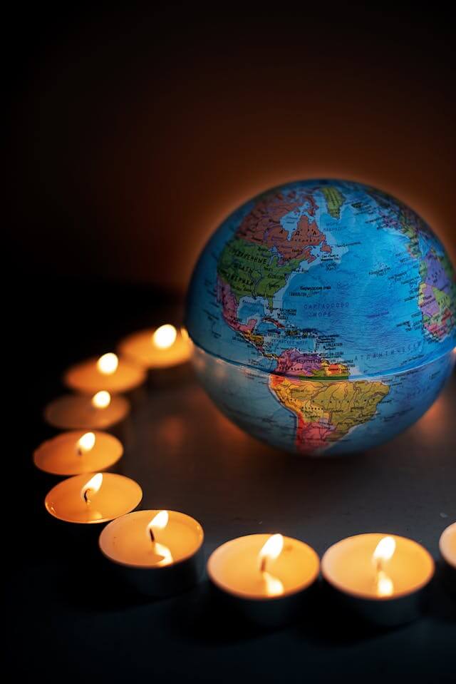 A globe of the world with candles sitting around it representing a distance healer.