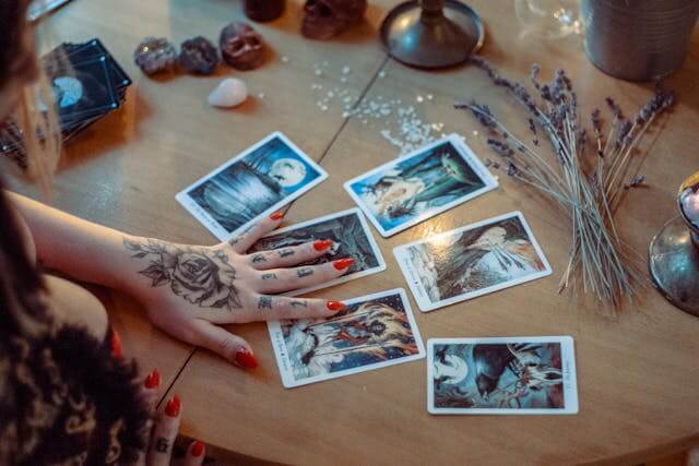 Psychic healing cards and crystals on a table.