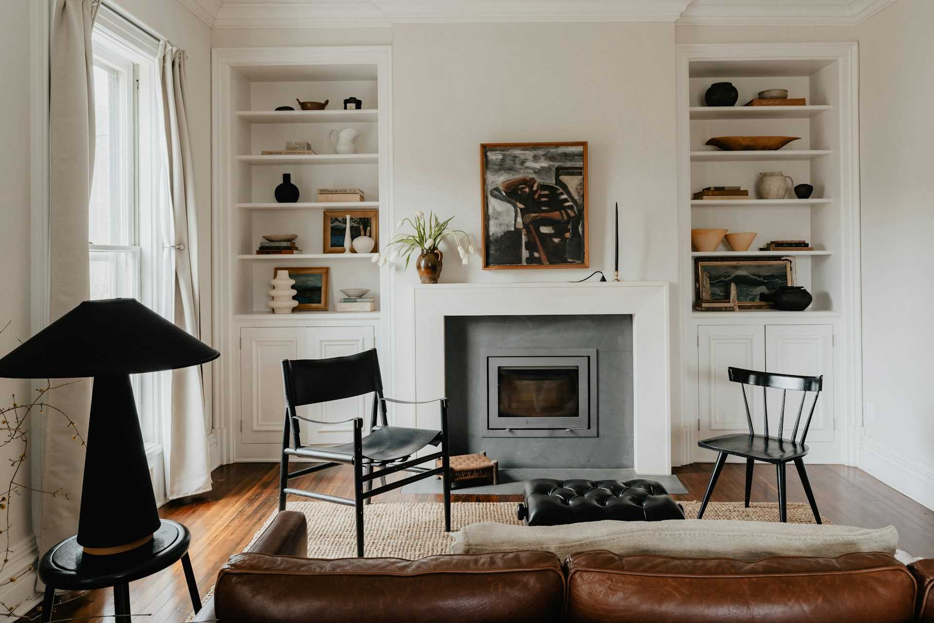 A clean living room with 2 chairs giving an example of how to live more mindfully.