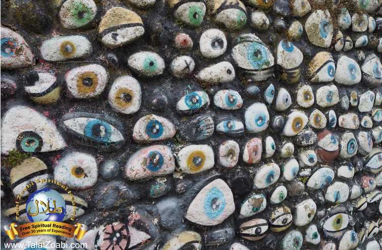 A wall of stones with painted eyes on all the rocks representing evil eye symptoms.