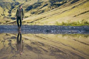 A man walking peacefully next to a river who did the closure with the deceased spiritual healing service done.