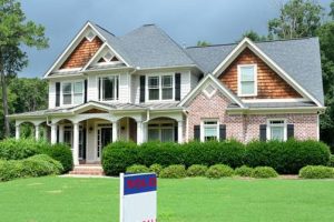 A home with a sold sign that the owners did the help selling a home spiritual healing service done.