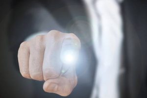 A man pointing at the screen with his finger lit up representing spiritual help.